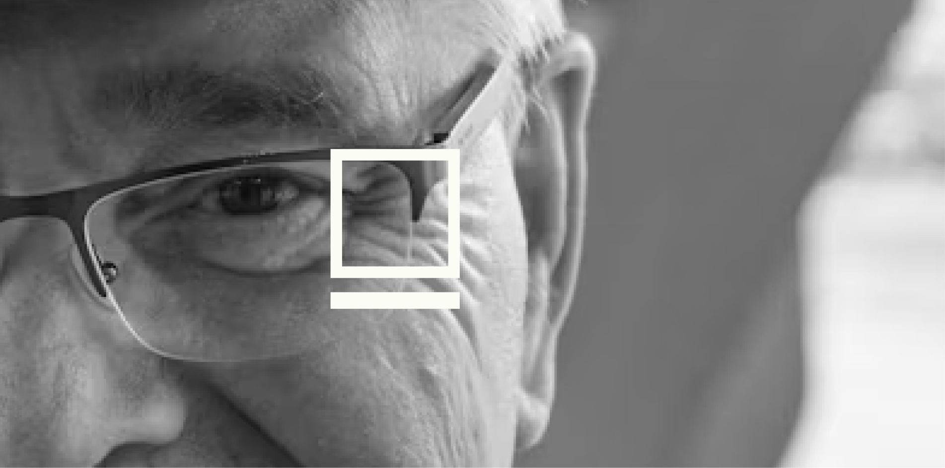 Monochrome portrait of an older man with the Blank Boxx square mark overlaid
